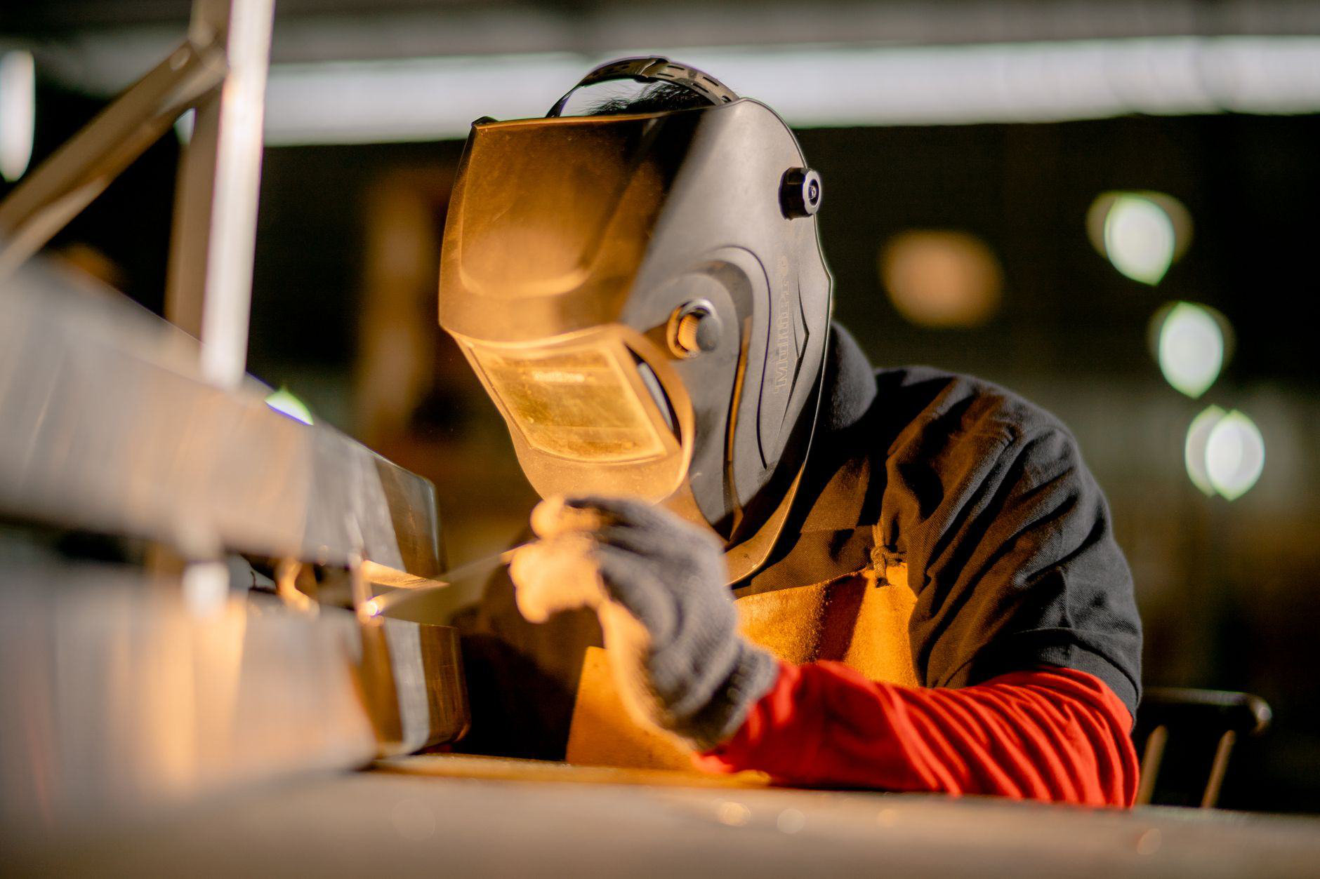 Welder finishing a fabricated assembly